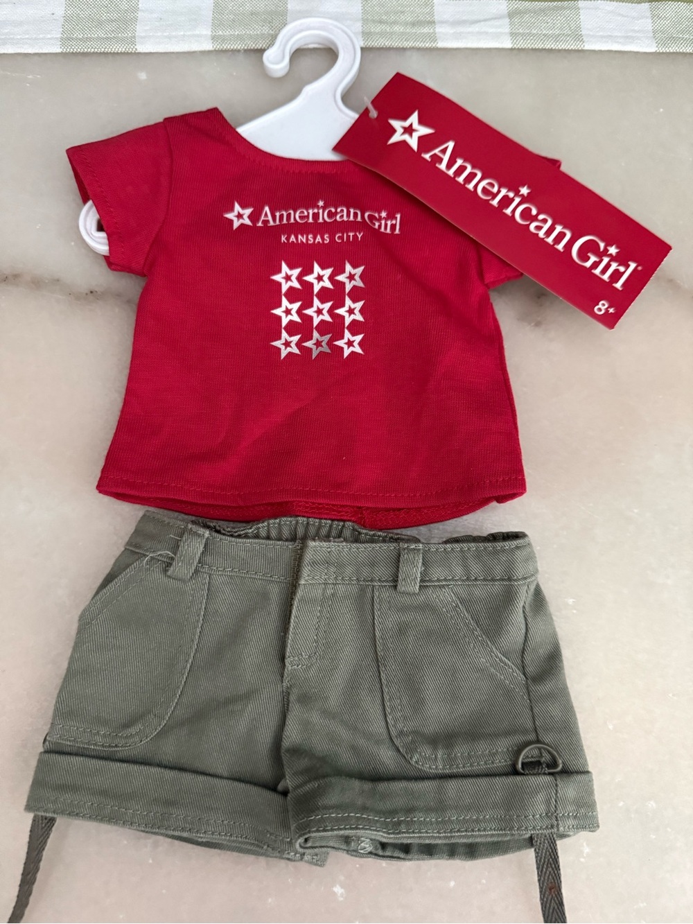 American Girl Red Star Logo Tee with Olive Cargo Shorts and hanger